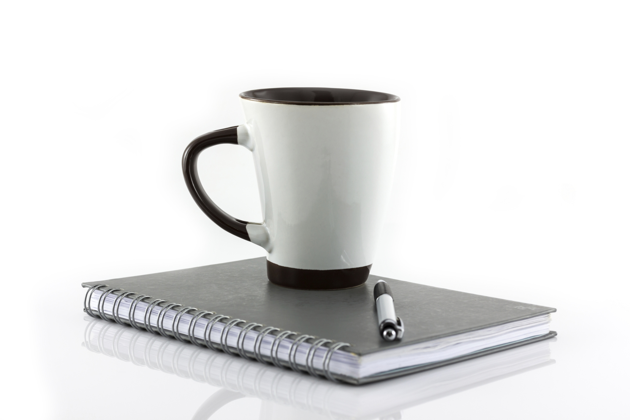 Cup of coffee and notebook isolate on white background